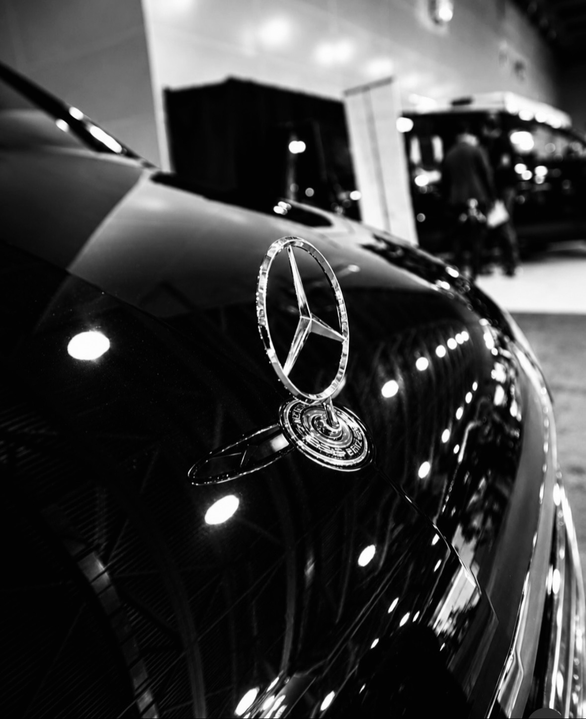 Mercedes-Benz star emblem on the polished black hood of our Sprinter