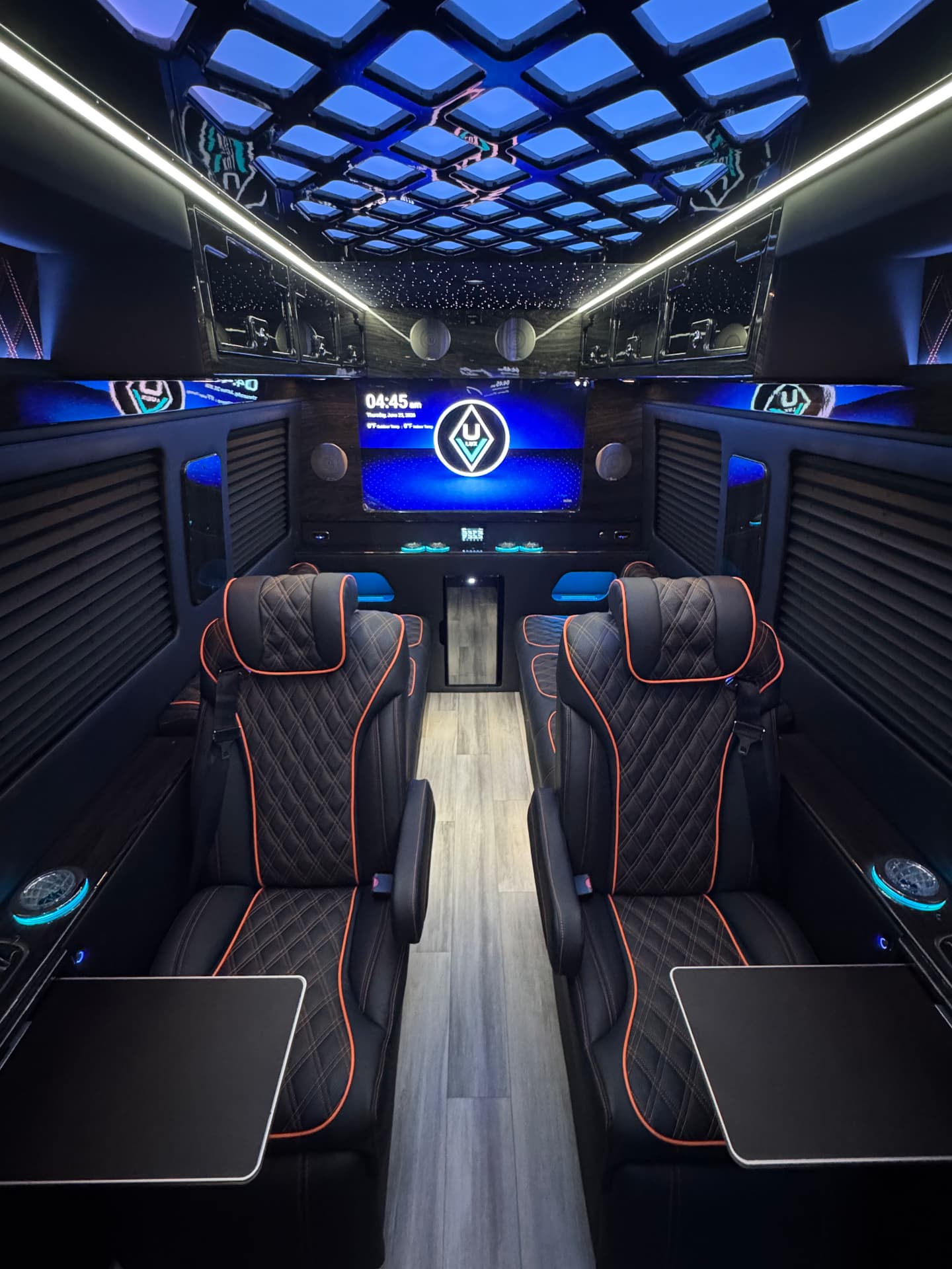 Cabin looking forward with LED ceiling and display screen